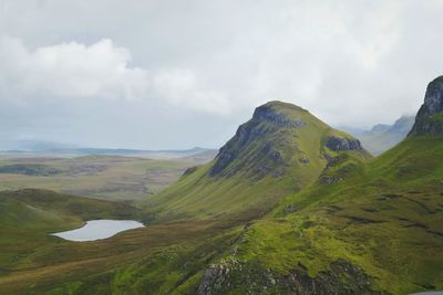 Scenic view of mountains against cloudy sky