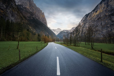 Road amidst trees against sky