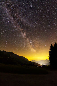 Scenic view of silhouette mountain against sky at night