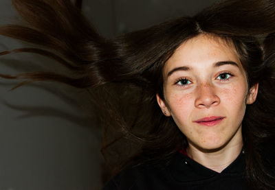 Close-up portrait of young woman with long hair