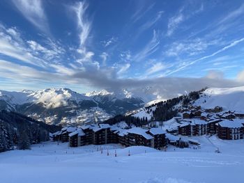 Scenic view of snow covered mountains against sky