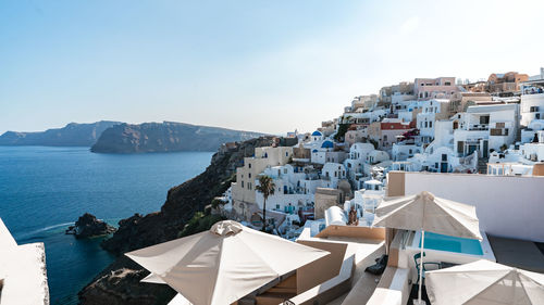 High angle view of townscape by sea against sky