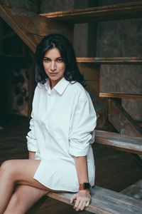 Portrait of a beautiful young woman sitting outdoors