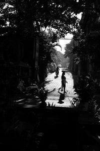 Silhouette people walking on road