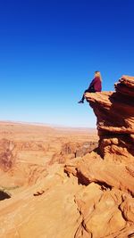 Rock formations in desert against clear blue sky