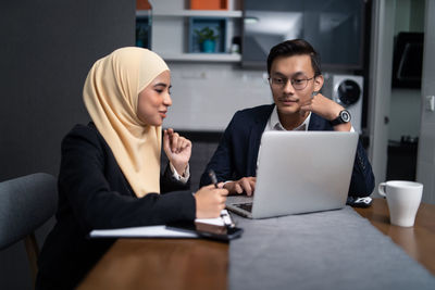 Business people working at desk in office cafeteria