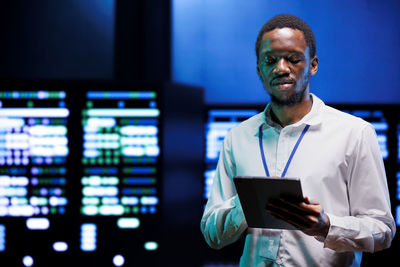 Portrait of businessman using digital tablet