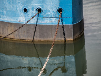 View of rope tied to boat moored in water