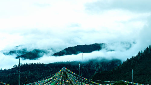 Buntings against mountains against cloudy sky