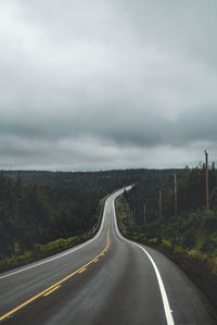 Country road against sky