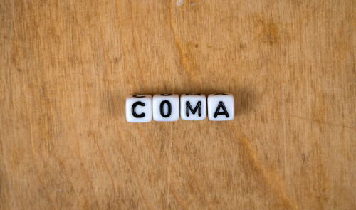 Close-up of information sign on wooden table