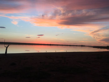 Scenic view of beach against sky during sunset