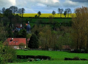 Scenic view of grassy field against cloudy sky