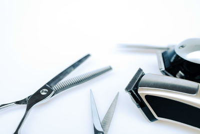 High angle view of tools on table against white background