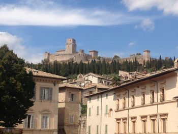 Low angle view of buildings in town against sky