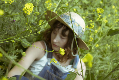 Portrait of woman holding plant