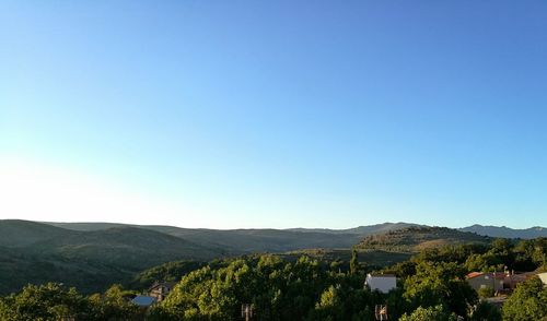 Scenic view of mountains against clear blue sky