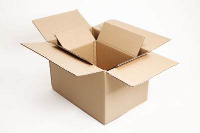 Close-up of cardboard boxes over white background