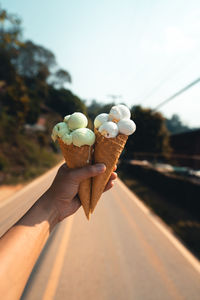 Close-up of hand holding ice cream cone