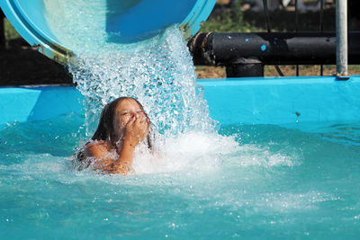 Girl enjoying in swimming pool at water park