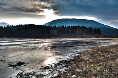 Scenic view of mountains against cloudy sky