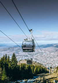 Overhead cable car against sky