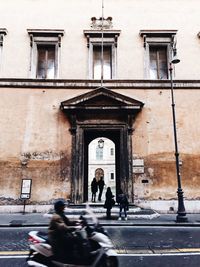 People walking in front of building