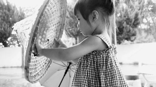 Side view of woman with girl standing outdoors