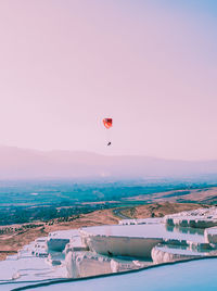 Hot air balloon flying over sea against sky