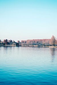 Scenic view of river against clear blue sky