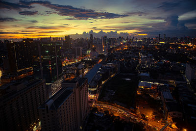 High angle view of illuminated cityscape against sky at night