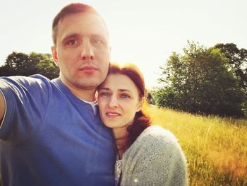 Portrait of happy friends against sky
