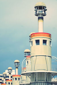 Low angle view of lighthouse against building