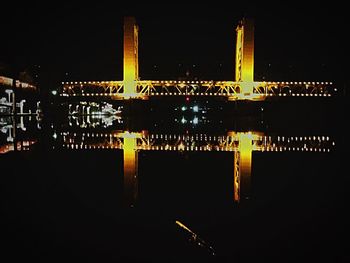 Illuminated reflection of built structure in water at night