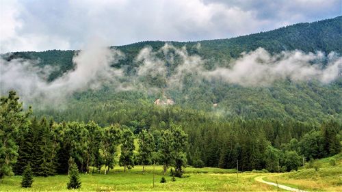 Scenic view of waterfall against sky