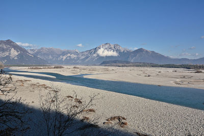 Scenic view of snowcapped mountains against clear blue sky