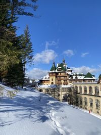 Buildings in city against blue sky