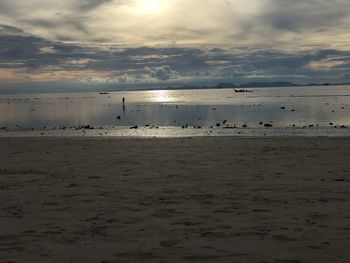 Scenic view of beach against sky during sunset