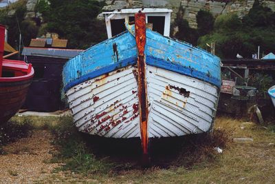 Old boats moored on field