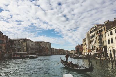 Canal amidst buildings against sky