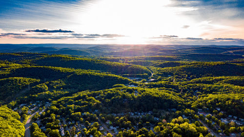 Scenic view of landscape against bright sun