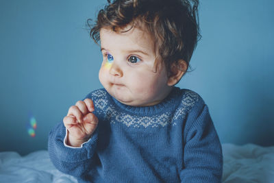 Cute baby girl on bed at home