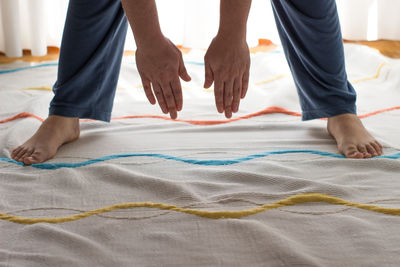 Low section of woman exercising at home