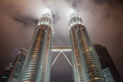 Low angle view of illuminated buildings against sky at night