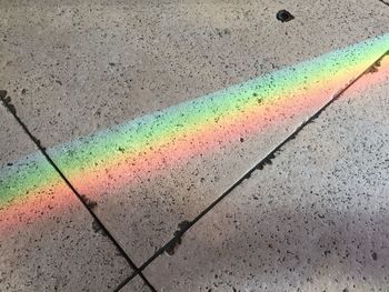 Close-up of rainbow on road