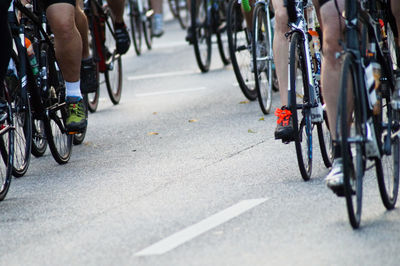 Low section of athletes cycling on road during race