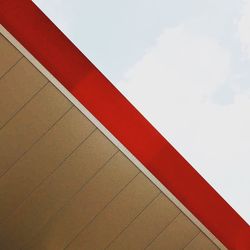 Close-up of red wall against sky