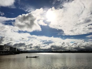 View of swan in water against sky