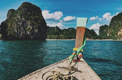 Wooden posts in sea against sky