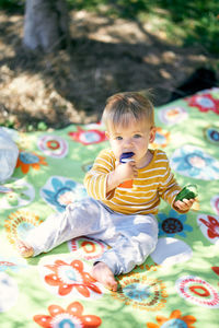 Cute baby girl sitting with toy